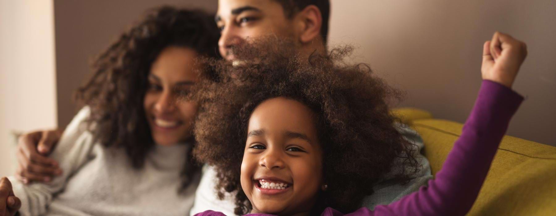 a family sitting on a couch