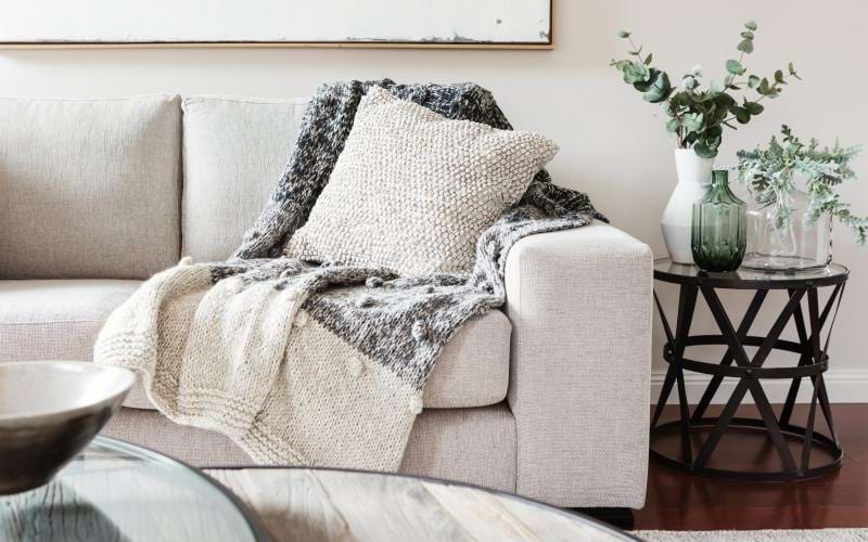 a couch with a pillow and blanket on it